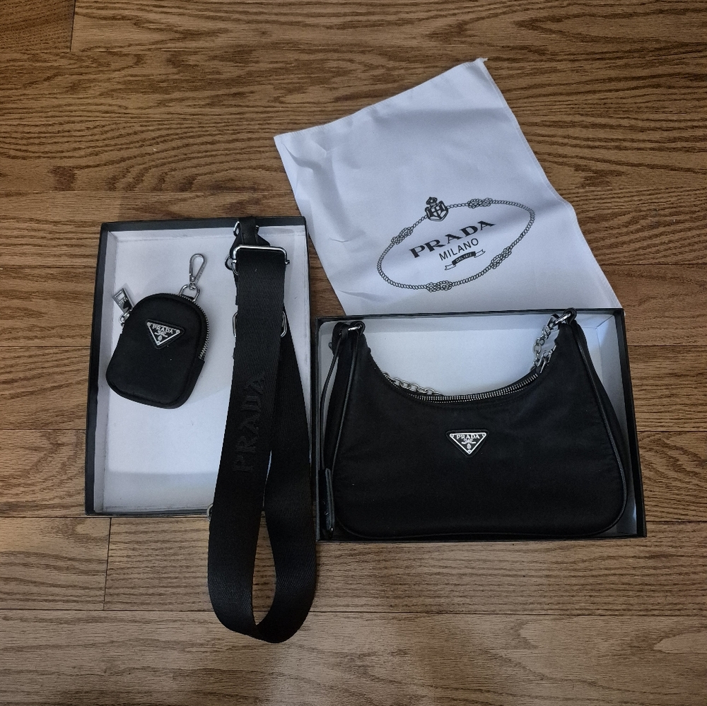 Black Prada purse with strap, white bag, and small change purse